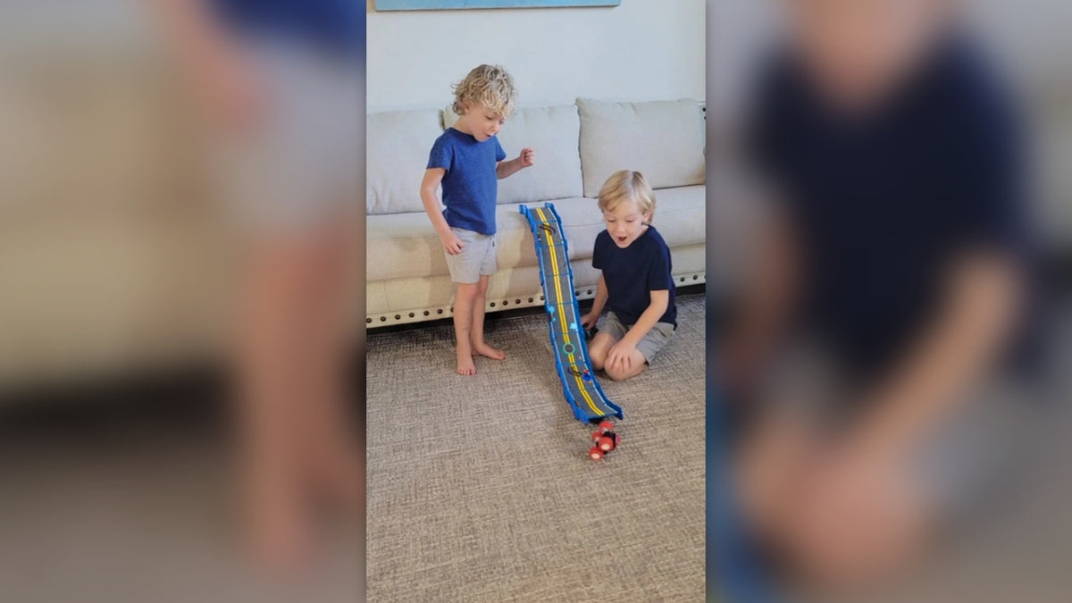 Kids sending a monster truck down a tall bright blue Redi-Rampz ramp