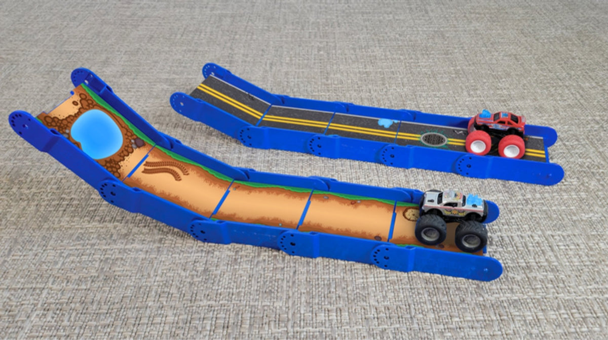 Two bright blue Redi-Rampz ramps side by side, one off-road and one street, with monster trucks